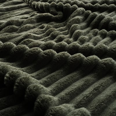 Dark green textured blanket, soft and plush with braided design, detailed texture.
