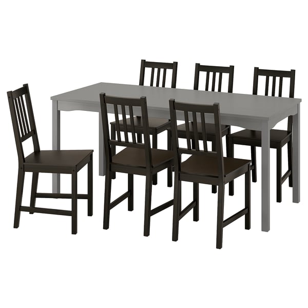 Rectangular dining table with 6 black chairs, wooden seats, slatted backs. Traditional design, ideal for kitchen or living room.