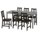 Rectangular dining table with 6 black chairs, wooden seats, slatted backs. Traditional design, ideal for kitchen or living room.