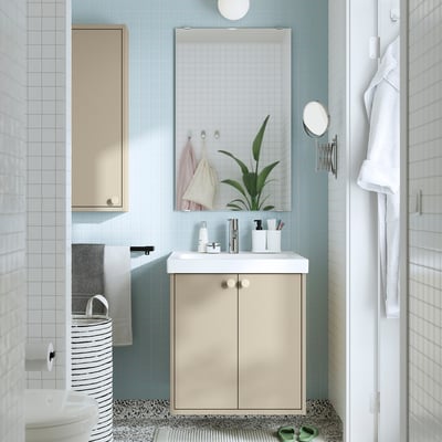 Beige HAVBÄCK vanity with blue tiles, larger than toilet.