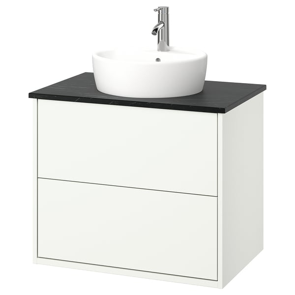 Modern white bathroom vanity with black countertop, round white sink, chrome tap.