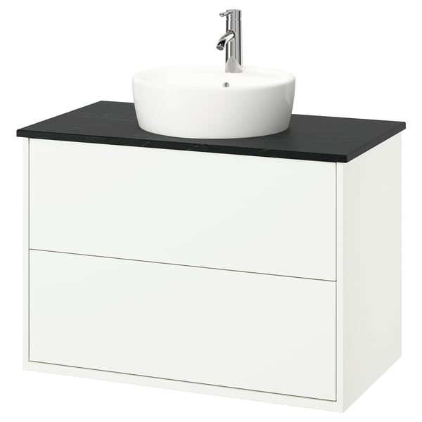 White wall-mounted bathroom vanity with black countertop, round white basin, chrome tap.