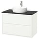 White wall-mounted bathroom vanity with black countertop, round white basin, chrome tap.