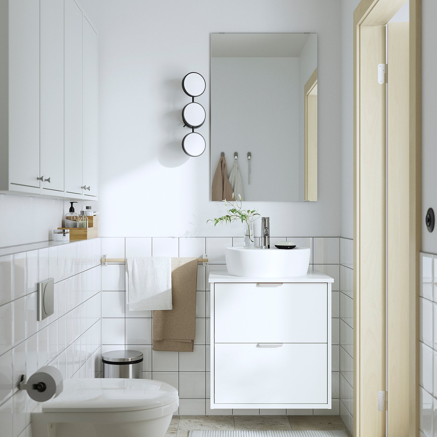 Modern bathroom with HAVBÄCK sink stand, round basin, full drawers, and wall mount. Includes toilet, mirror, and towels.