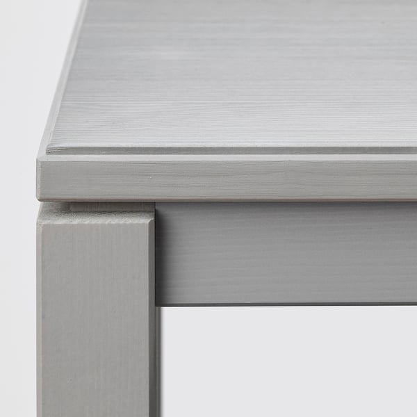Close-up of polished, brushed metal surface on stylish console table, showcasing sleek design and quality finish.