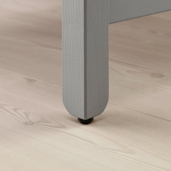 Close-up of HAVSTA table leg, smooth brushed finish, solid pine, sturdy design.