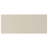 A rectangular, beige-colored HAVSTORP front piece made from acrylic-painted fibreboard.