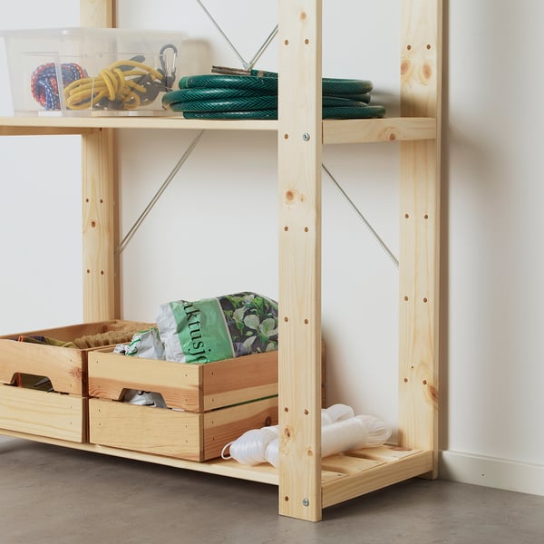 Wooden garage shelves with tools, gardening supplies, and ropes.