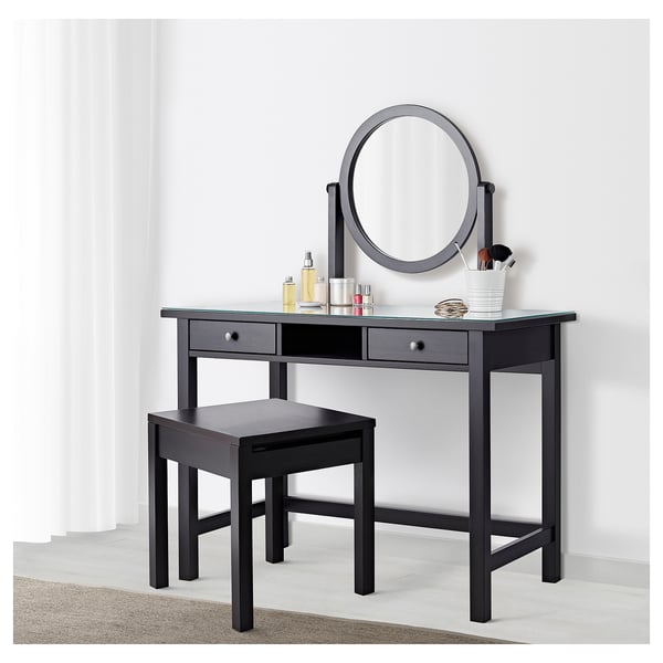 Black dressing table set with mirror, stool, and storage for makeup.