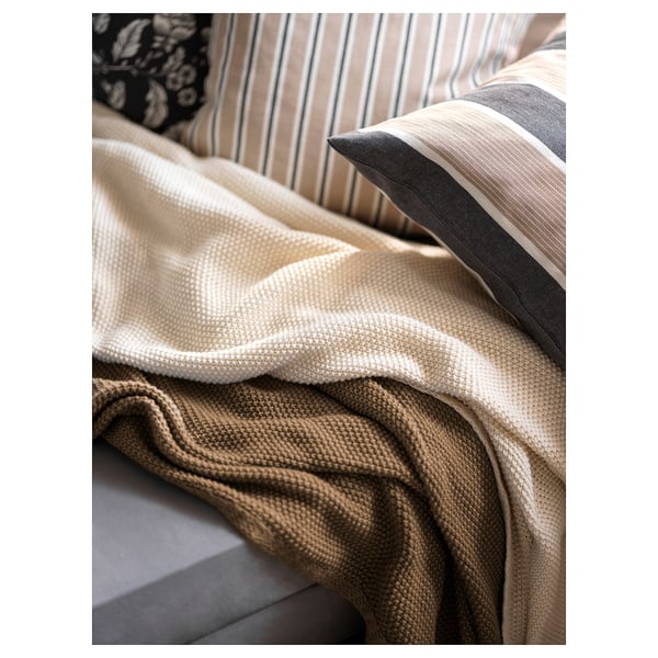 HUMLEMOTT off-white throw blanket, soft & cosy, partially covers large couch, textured knit design, made from recycled polyester.