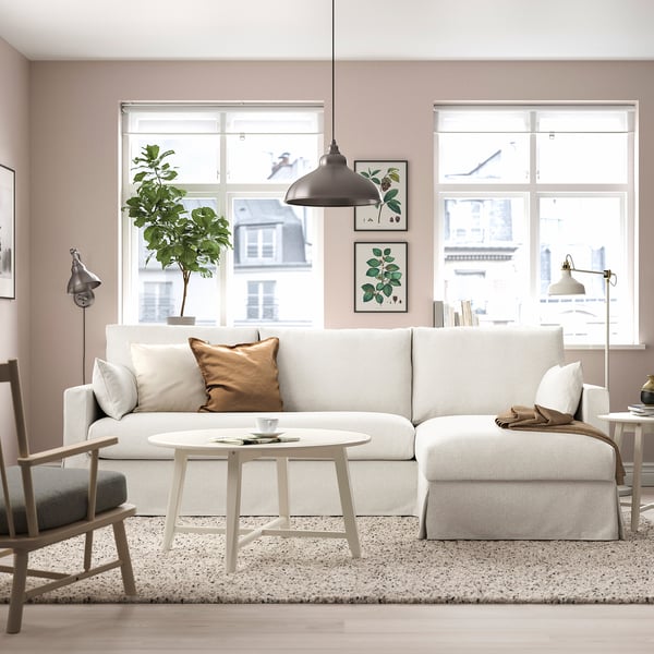 Modern living room with HYLTARP sofa, pendant light, side table, floor lamp, large windows, plant, and wall art.