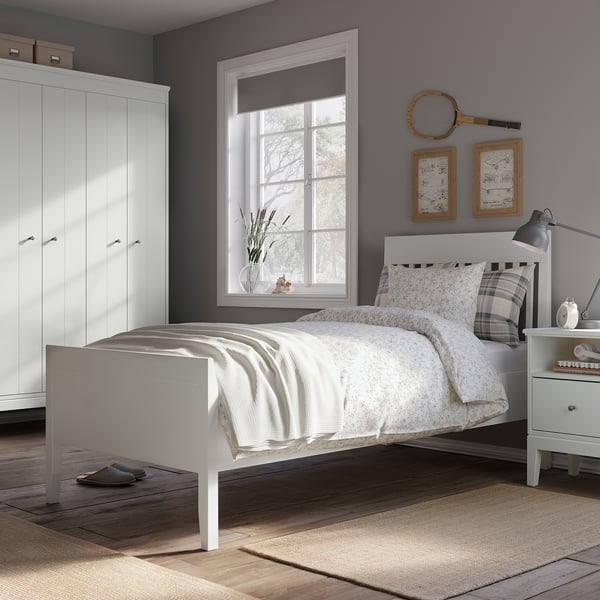 Modern grey bedroom with white IDANÄS bed, wooden floors, and large window.