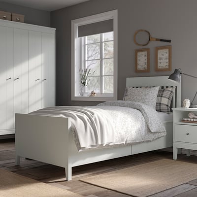 Modern bedroom with white IDANÄS bed, storage, grey closet, wooden decor, and plaid pillow.