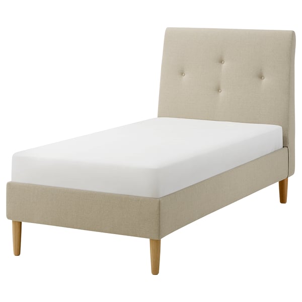 An IDANÄS beige upholstered bed with a sloping headboard and wooden legs. Its a stylish, comfortable bed frame designed for a cosy bedroom.