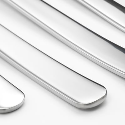 Four polished steel spoons lie neatly together, reflecting light, showcasing their sleek, modern design.