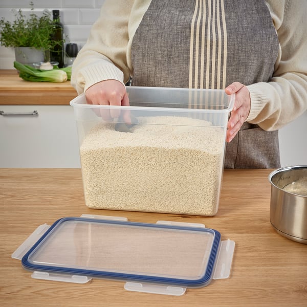 Person holding a large container of grains in a kitchen, showcasing the leak-proof lid of the IKEA 365+ series.