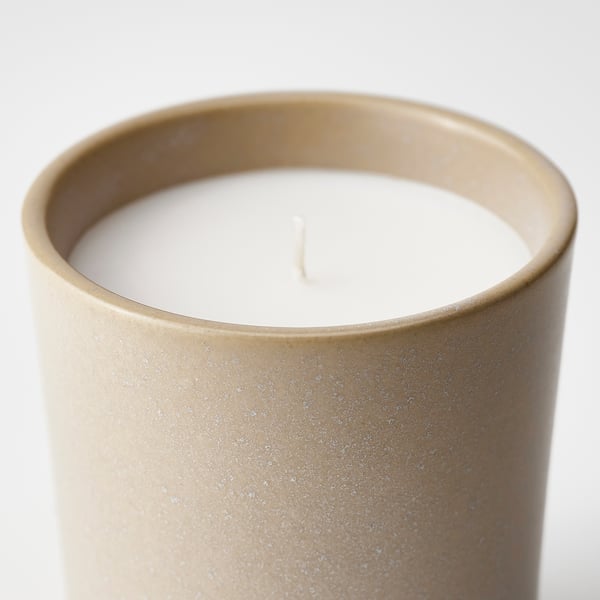 Beige candle holder with vanilla scent.