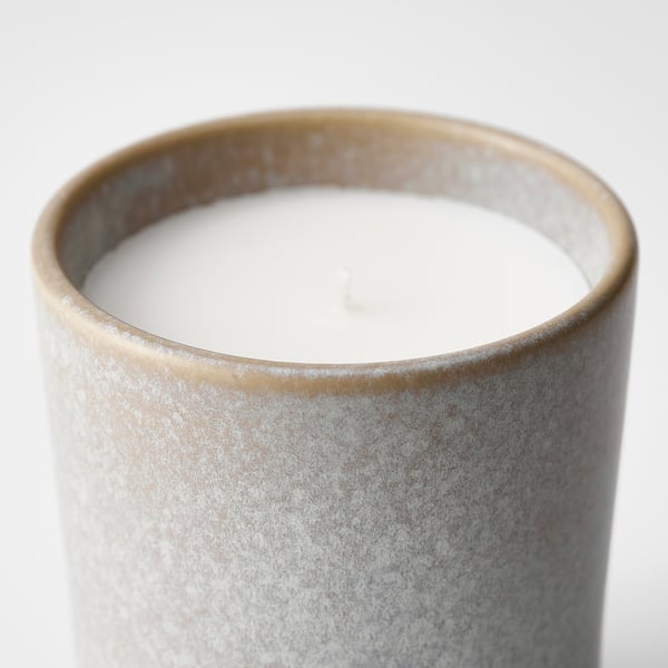 Candle with smooth white wax, grey glaze, floral scent.