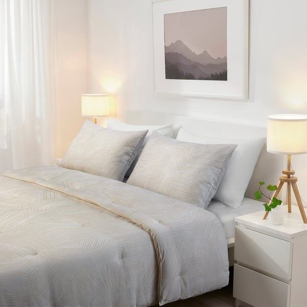 Minimalist bedroom with JÄRNTRÄD bedding, nightstands, and mountain art.