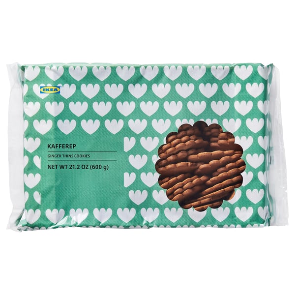 A package of IKEA KAFFEREP ginger thins cookies, featuring a green, heart-patterned background with stacked cookies.