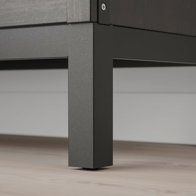 Black metal shelf leg with textured finish supporting flat surface.