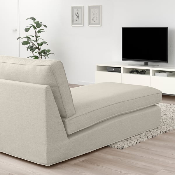 Modern living room with KIVIK chaise, light grey, wood floor, tv, games, plant.