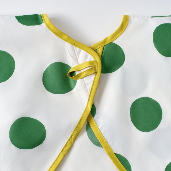 KLADDIG bib close-up: yellow ties, green polka dots, soft fabric. Stylish, adjustable, quality childrens bib.