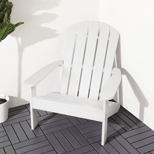 White KLÖVEN adirondack chair on grey deck, large and relaxing with high back and wide armrests.