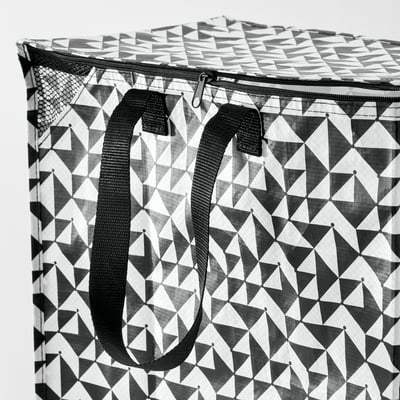 Black and white geometric-patterned reusable shopping bag with sturdy black handles and zip top, indicating durability and practicality.