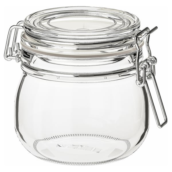 A clear glass KORKEN jar with an airtight lid and metal clamps, suitable for storing food and preserving freshness.