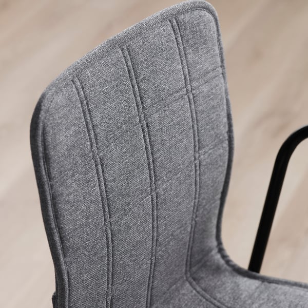 Close-up of grey fabric on ergonomic office chair, showcasing quality stitching and design.