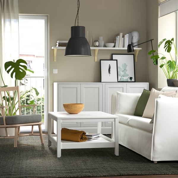 Modern living room with LANDBANA jute rug, white coffee table, and couch on grey carpet.