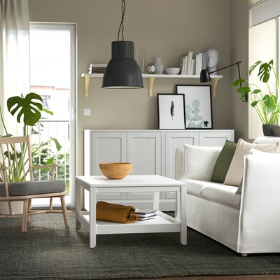 Modern living room with LANDBANA jute rug, white coffee table, and couch on grey carpet.