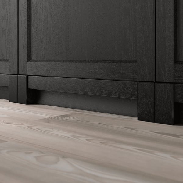 Black wooden kitchen cabinet plinth attached to a light wooden floor. Part of the LERHYTTAN series, enhancing traditional kitchen design.