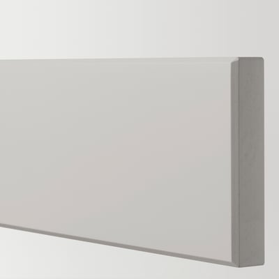Close-up of a modern, finely crafted light grey kitchen drawer edge, showcasing smooth, bevelled solid birch wood.