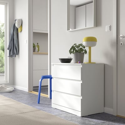White LILLBERGET chest with 3 drawers, lamp, plant, blue stool for small entryways.
