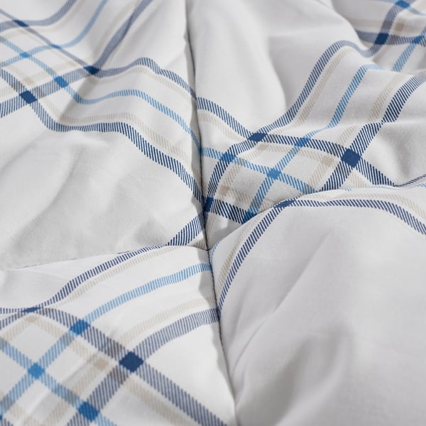 Close-up of a blue and white chequered comforter, showcasing its intricate pattern and smooth fabric texture.