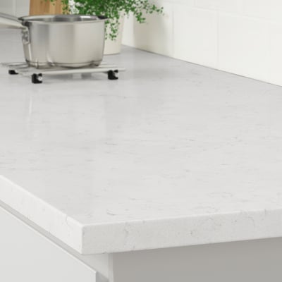 A sleek white kitchen countertop made of recycled glass, showcasing its durable, stain-resistant, and easy-to-clean surface.
