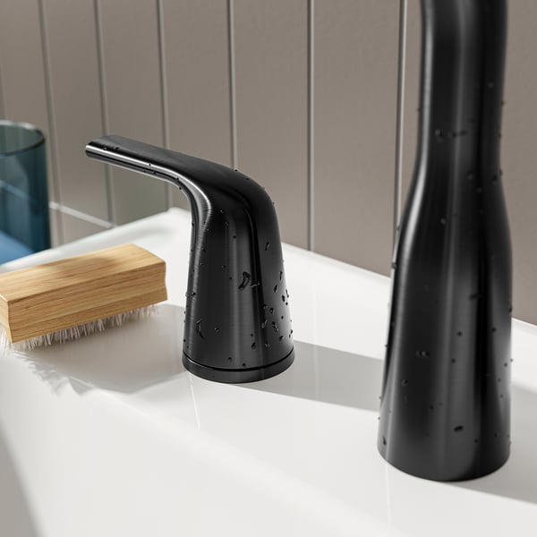 Modern bathroom tap with sleek, curved design and matte black finish, featuring a stainless steel handle and spout.