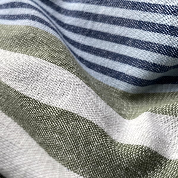Striped shower curtain close-up, soft cotton texture, calming blue and white stripes.