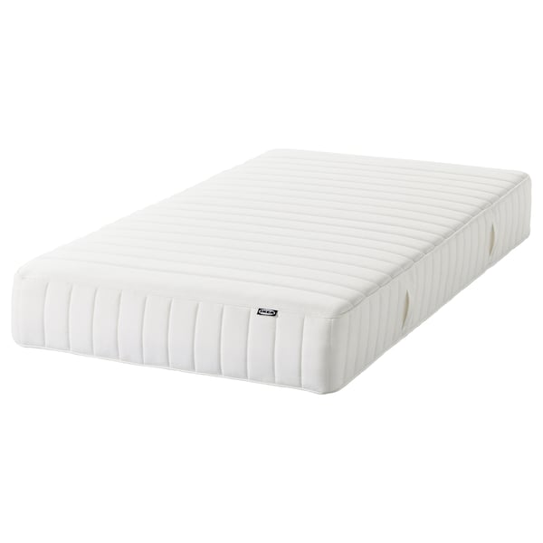 Ikea MALM bed in white, featuring a quilted headboard and flat platform, ideal for versatile bedroom layouts.
