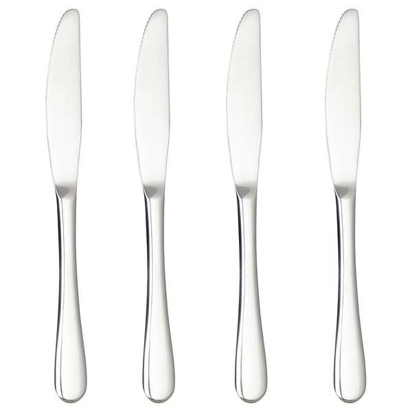 Four stainless steel knives in a row, sleek and polished, ideal for elegant dining.