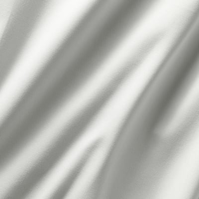Close-up of plush, dim-out curtains with intricate weave texture, showcasing quality fabric.