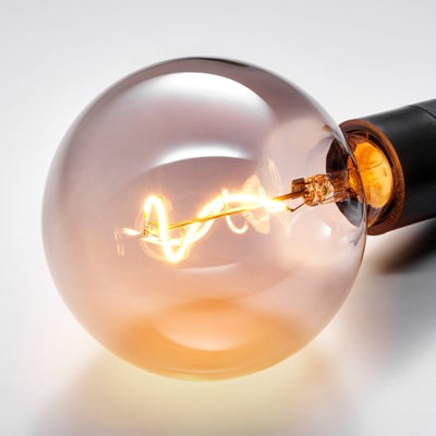 Close-up of warm, spiral filament in vintage light bulb.
