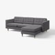 Modern grey l-shaped sofa with tufted cushions, wooden legs, and clean lines.