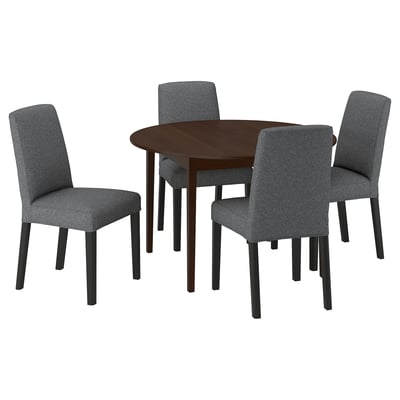 Modern dark brown round dining table with four grey upholstered chairs. Simple, sleek design.