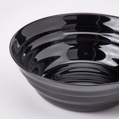 Black glossy bowl with circular ripples pattern, smooth edges, reflective surface.
