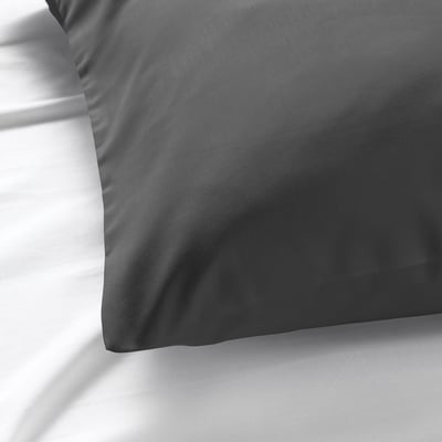 Close-up of smooth, luxurious grey pillowcase displaying fine fabric texture.