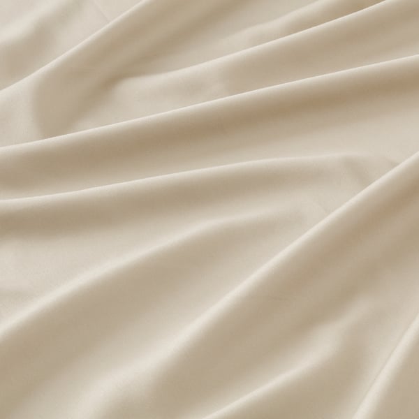 Soft cream sateen sheet with lustrous finish, showcasing smooth fabric texture and elegant folds.
