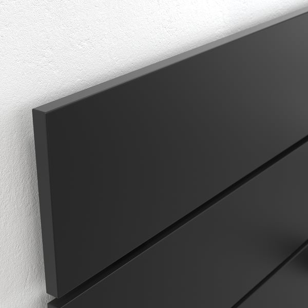 Dark grey bed frame corner, sleek finish, smooth edges.